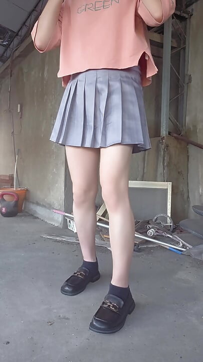 A Pleated Skirt Paired with White Underwear, and an Anal Plug Inserted on the Terrace