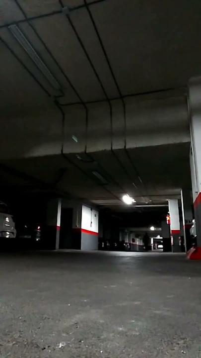 Naked in an underground parking lot