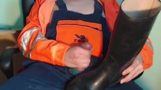 Worker cumming on rubber boots while watching porn
