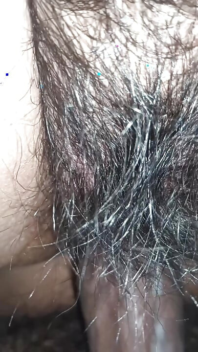 Close up view on a hairy and creamy pussy