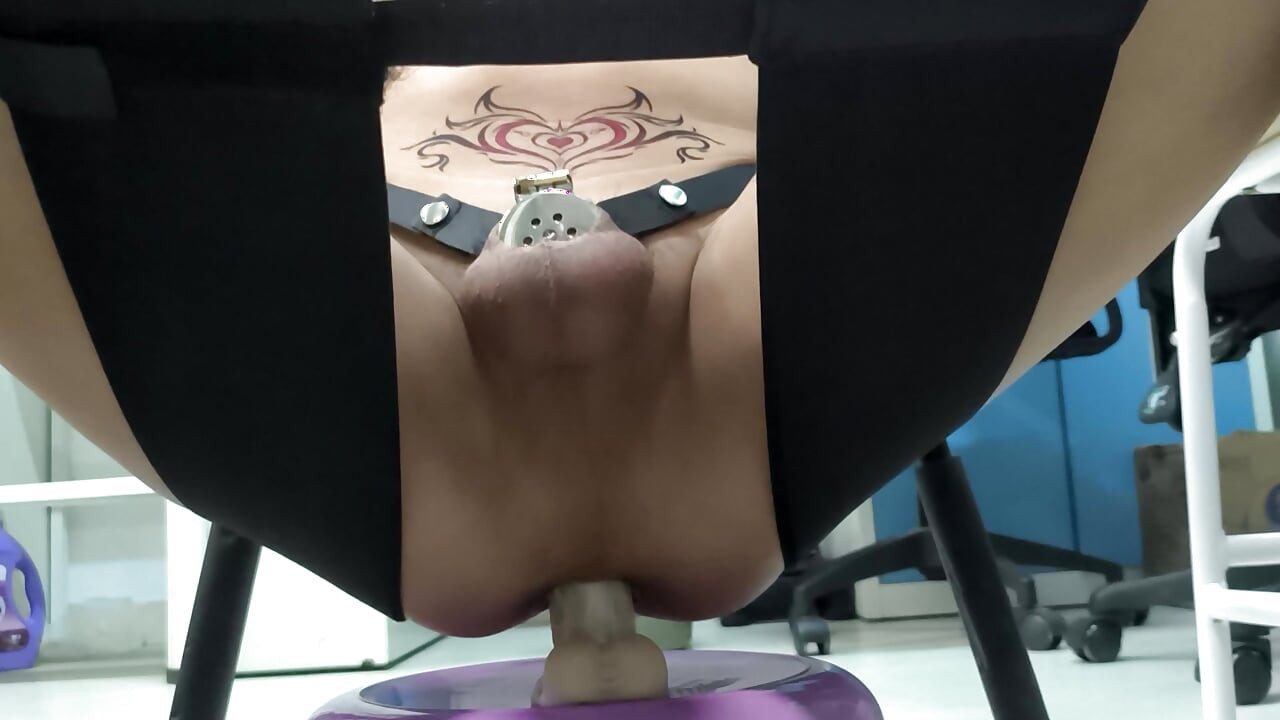 Sitting in a chair and using a dildo to masturbate in chastity
