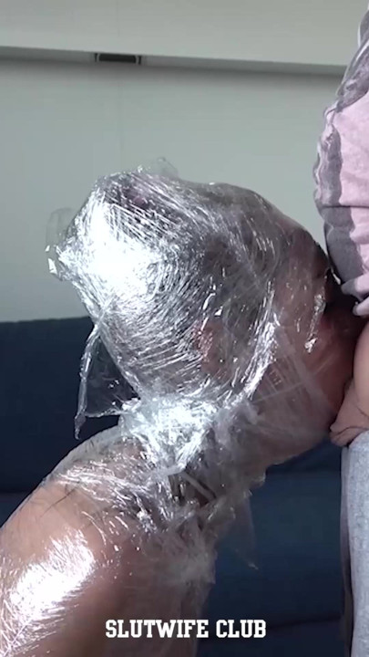 Plastic wrapped Candie Cross sideview, skinny body sealed, kneeling immobilized
