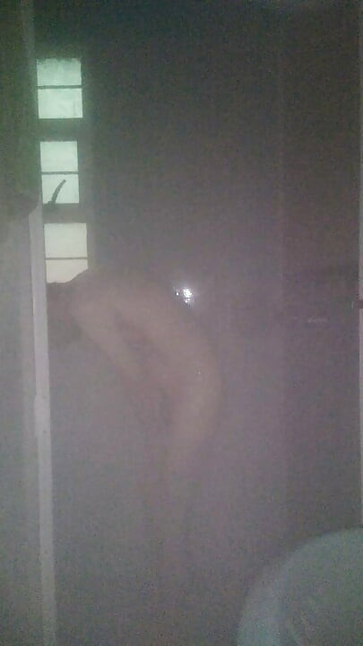 Man Showering with Flashlight On