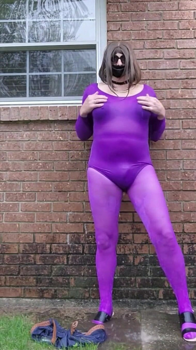 Stunning moment from "Crossdressed outdoors in nylon bodysuit getting wet in the rain."