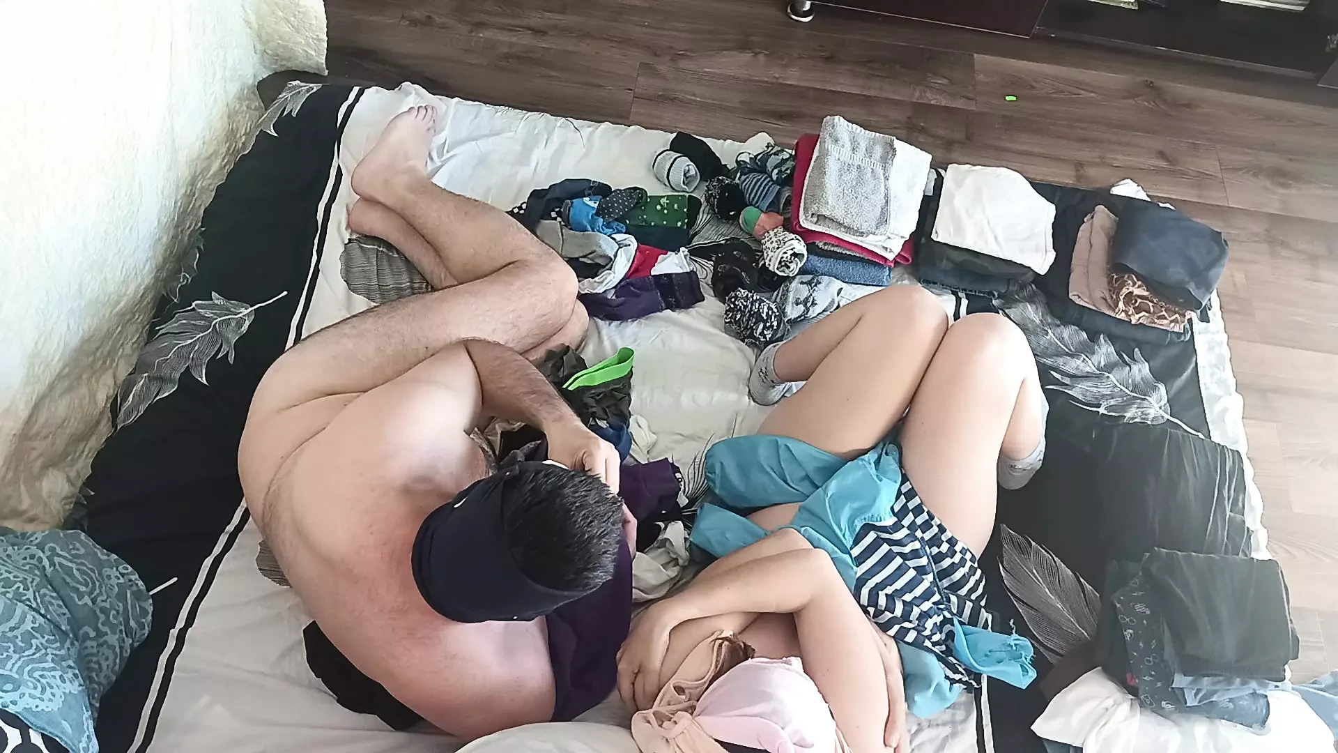 Foreplay in the bedroom with an amateur couple.