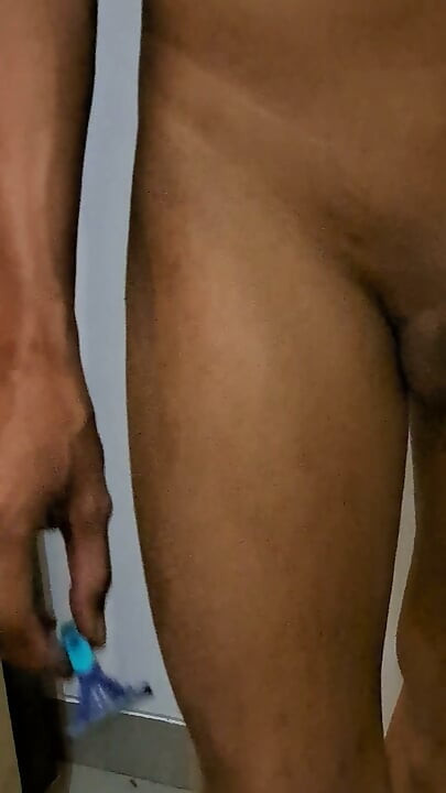 Exotic skinned asian adult man shaving his dick