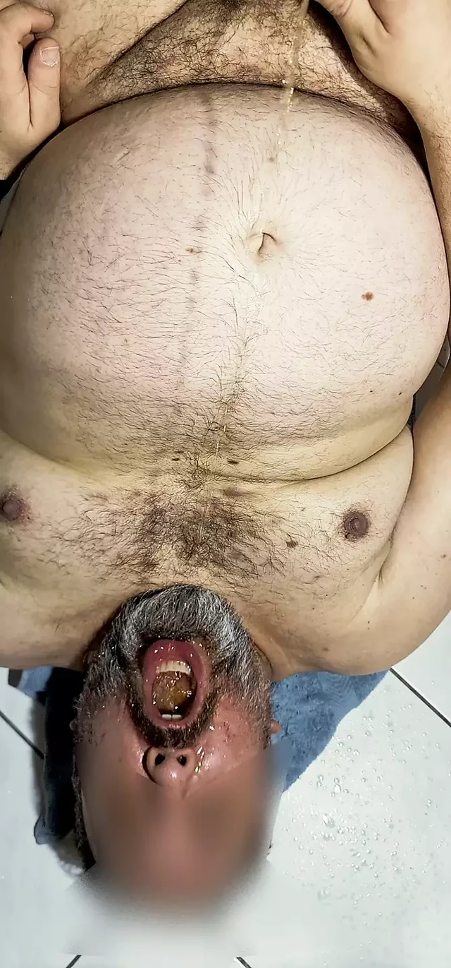 Bearded bear pissing in his mouth and drinks it