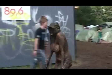 Topless Danish girl covered in mud at Roskilde Festival