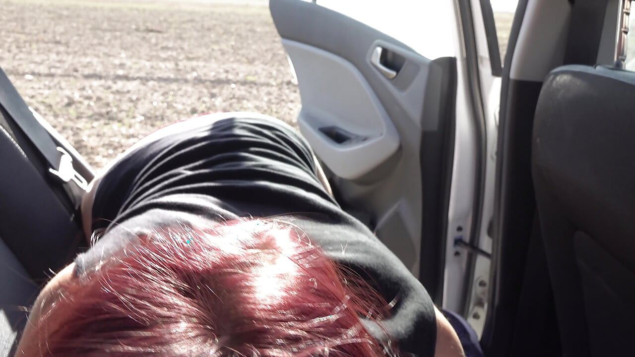 Redhead chick sucks big pecker in the car
