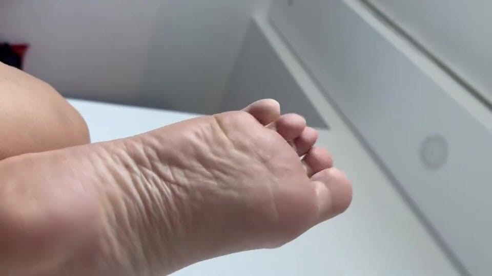 Laying in bet with bare feet