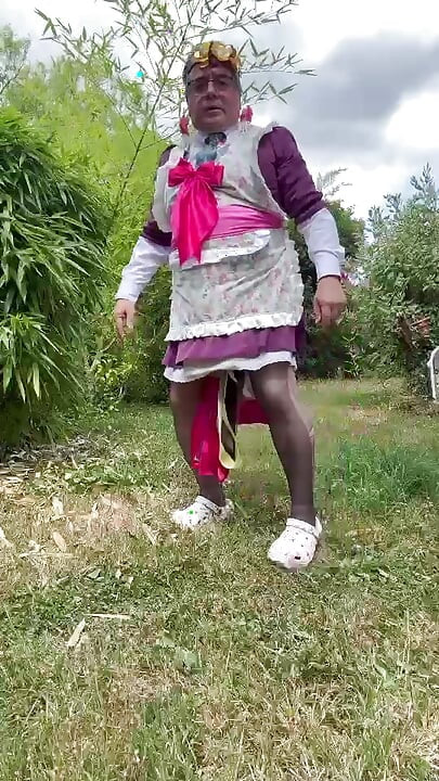 In gardener's outfit, peeing on all fours like a dog
