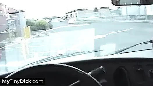 A busty babe in a car sucking her friend's small dick