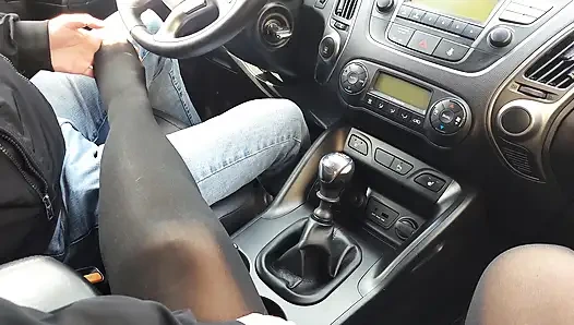 Stylish woman teases taxi driver in the car with her sexy legs