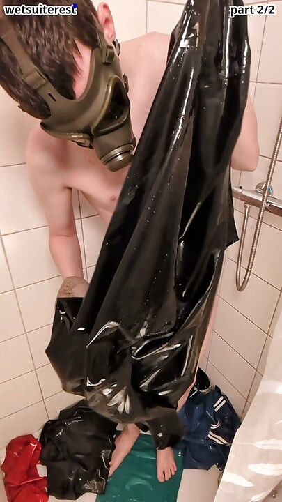 Latex laundry in shower wearing rubber gas mask