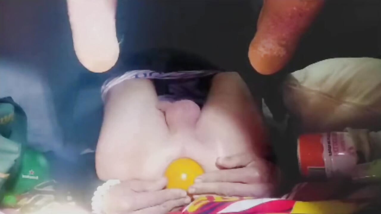 Một chàng trai trẻ nhét một quả cầu pha lê và một quả cam lên cái mông săn chắc của mình.