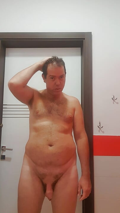 A boy completely naked in a station bathroom