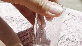 Inserting a small cup into the wet pussy