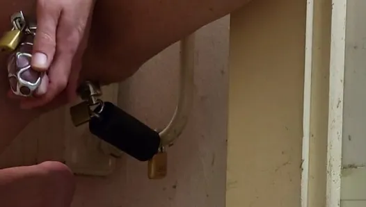 Anal chastity buttplug chained to the radiator with ice lock