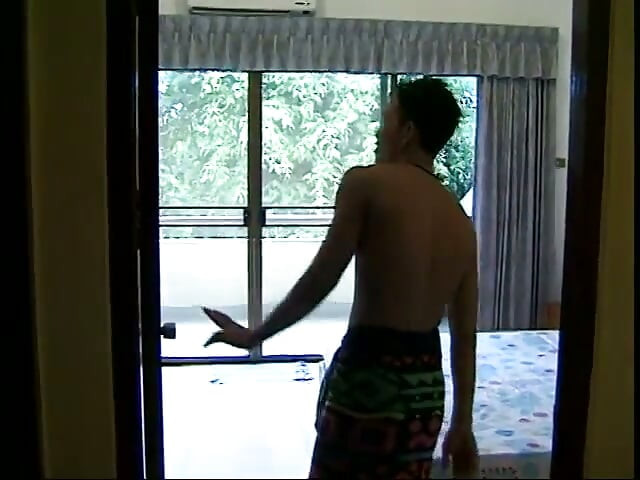 Horny Thai strokes his hard cock in bed