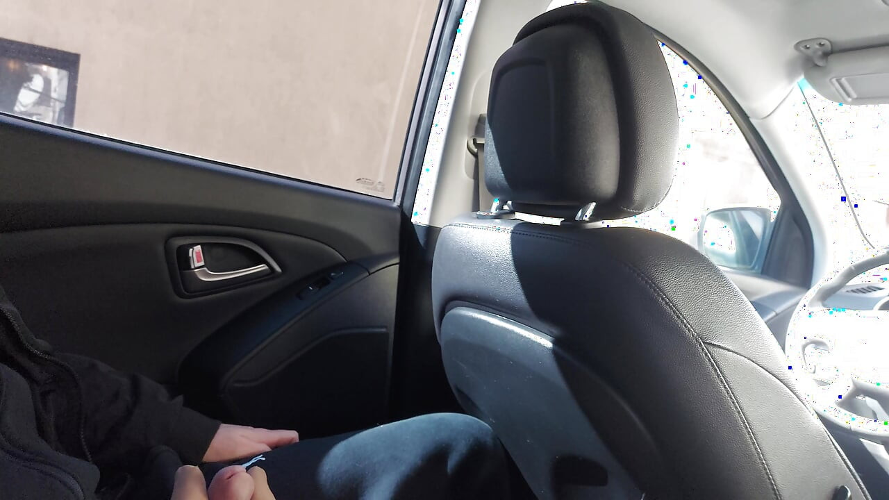 Elegant stepmom in stockings teases her stepson in the car, in public, and rubs his cock with her feet