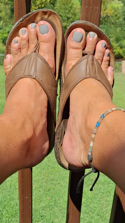 Showing off my new pedicure with toe rings and flip-flops