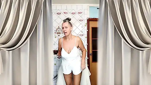 Real home solo of a mature woman in a small cozy kitchen.