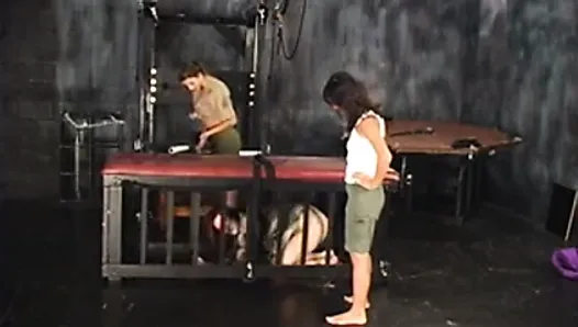 Three lesbians in torture chamber strip and one bends over for spanking