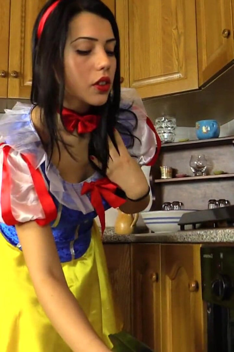 Hot brunette dressed as snow-white massages her feet
