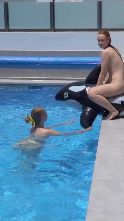 Lesbian Girls Are Having Fun in a Pool with an Inflatable Shark