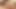 Latin woman pleasuring herself with a dildo.