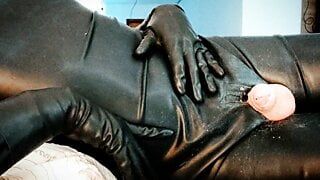 Cuming in latex gloves and latex bodysuit