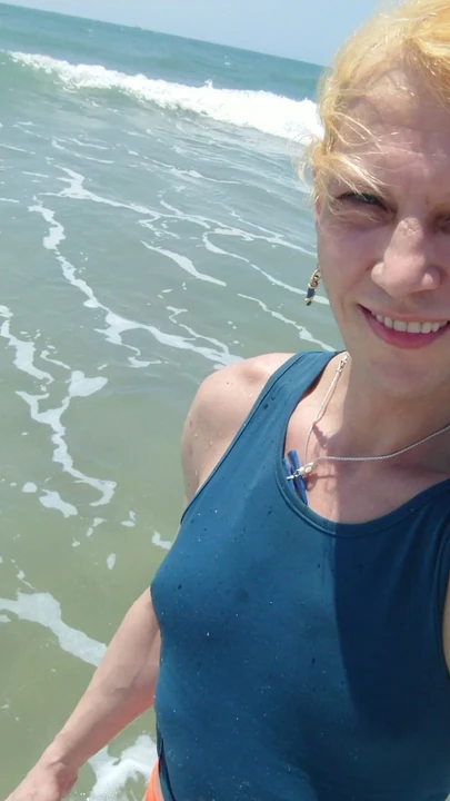 Transgirl swimming in red panties and blue t-shirt in Pacific ocean first time. Enjoying sun and hot weather. Wetlook tits in t