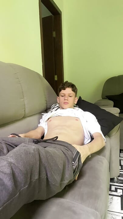 Skinny twink showing his big dick at the sofa