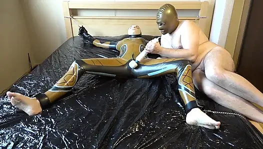 Latex Danielle is attached to the bed and masturbated with the massage vibrator