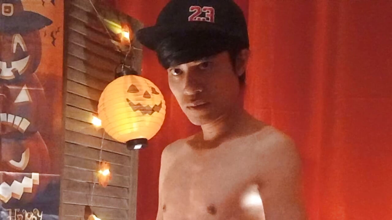 Cute twink Jon Arteen performs a sensual dance while carving a Halloween pumpkin