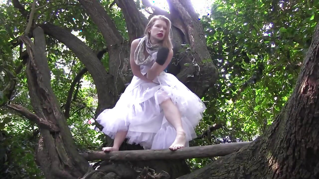 She climbs on tree and fingers her pussy