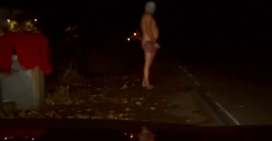 Interrupted while cutting off clothes , had to hide infront of car crouched down till car passed