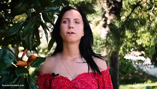 Sultry Brunette in Red Dress Smoking Rolled Cigarette