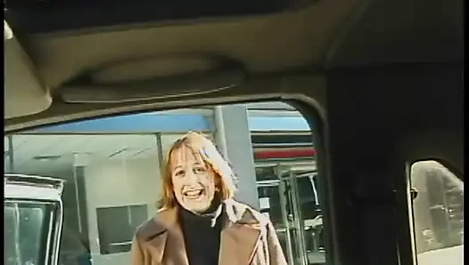 Commuter redhead carpools with creep who debases her in car in city traffic