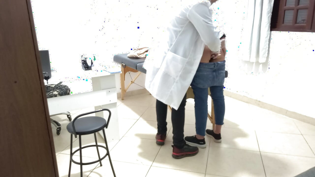 Proctologist performs anal exam on constipated patient.