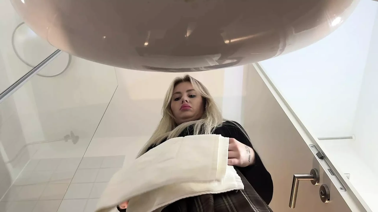 Big Tits Big Ass Hot Blonde Babe in Pantyhose and High Heels with a Miniskirt does a Striptease in the Bathroom