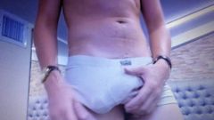 Slim young twink rubbing his huge bulge in tight shorts