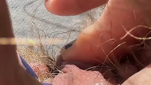 Amateur behaartes amateur-mädchen mastubiert in nahaufnahme mit riesigem kitzler