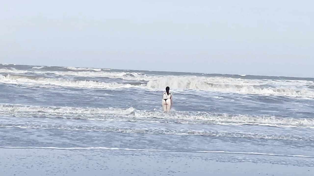 My neighbor loses her clothes at the beach.