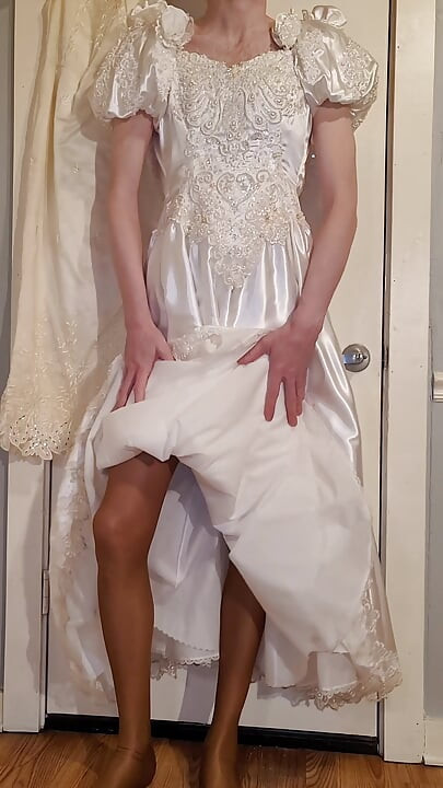 Trying on a liquid satin wedding dress.