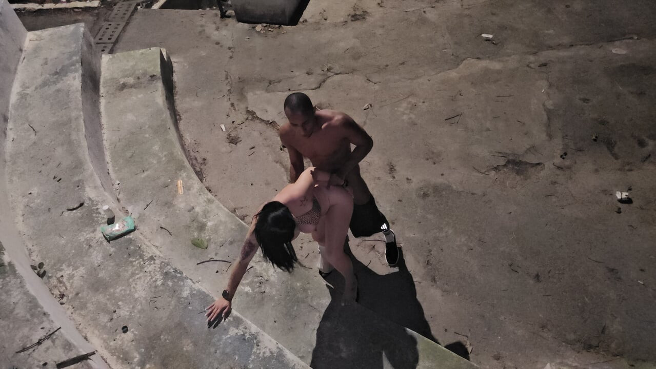 A black man with a big penis finds a hot woman in a public square and bangs her.