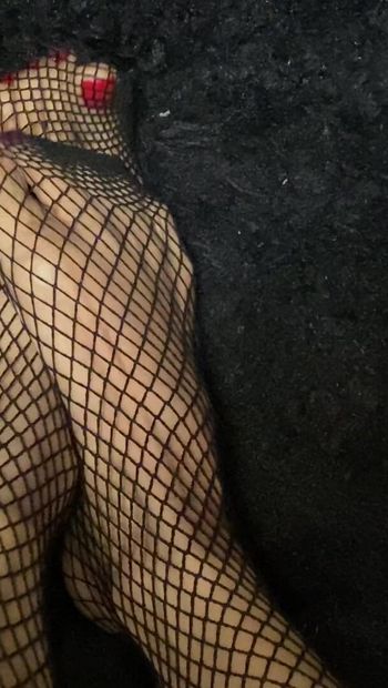 Fishnet stocking with sexy feet in red nail polish