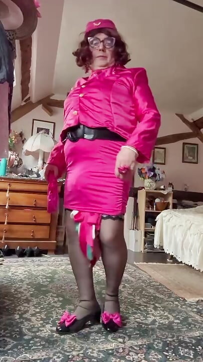 in a fuchsia flight attendant outfit for an evening