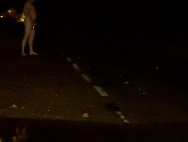 Naked in road and hiding the wrong side of road from safety when car passed