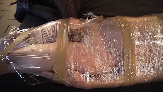 Femdom girl puts her slave in tape bondage